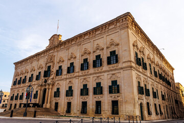 Il-Berġa ta' Kastilja - Facade of the Baroque inn from the 1740s, now flanked by historic cannons and housing the prime minister’s office, Valletta, Malta, Europe