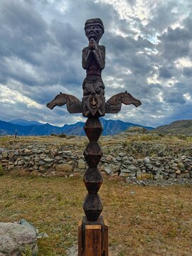 Handmade wooden carved ceremonial horse hitching post, totem pole in mountain valley near Mongolia. Altai Republic, South Siberia, Russia