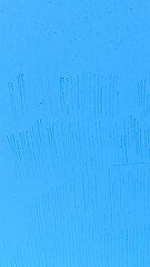 light blue textured surface with vertical lines