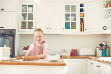 Baking, happy and portrait of child in kitchen with dough for learning to bake cake, dessert and pastry. Home, culinary skills and young girl with ingredients, recipe and food for sweet treats