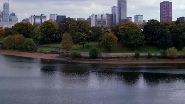 Skyline reveal of Birmingham from edgbaston reservoir