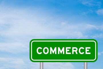 Green color transportation sign with word commerce on blue sky with white cloud background