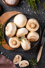  Fresh raw champignon mushrooms on gray background vertical photo