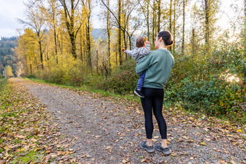 Fototapeta premium Mother and Child Enjoying Autumn Walk in Harrison Mills