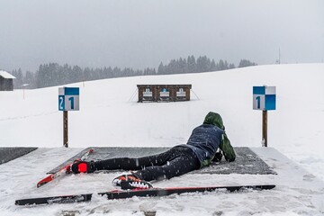 Boy doing target practice with a laser gun for biathlon training in winter