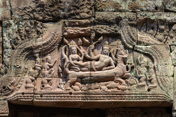 Wonderful lintel of ancient Narai Banthomsin on monster naga and dragon in the sea of Preah Khan temple, Siem Reap, Cambodia.