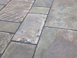 Grey stone paving on a British pavement