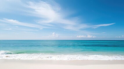 Fototapeta premium A mesmerizing view of a beautiful sandy beach with soft blue ocean waves gently crashing onto the shore, beach, coast, travel