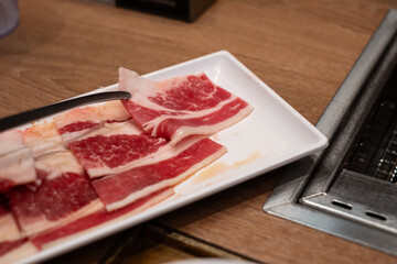 Delicious fresh raw juicy kobe wagyu marbled beef pork meat slice on plate ingredient for food sukiyaki yakiniku steak healthy meal Japanese traditional dining culture restaurant high protein bar-b-q