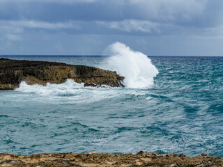 waves crashing into a clifff in Hawaii