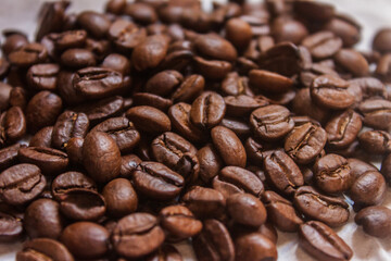 Coffee beans artistic shot, brown bean, arabica and robusta, café, caffeine, white background, freshness, shot is selective focus with shallow depth of field, taken at Cairo Egypt