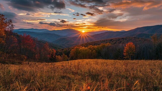 Scenic autumn mountainscape with fields, hills, and sunset.