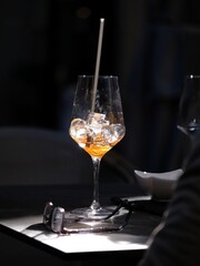 A glass of cocktail with a straw
