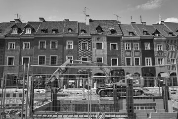 Construction equipment and facades of historic tenement houses during the renovation of the Market Square in Poznan