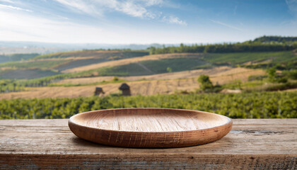 Fototapeta premium Handcrafted round wooden plate with rustic rural view background, empty plate for food. Mock-up