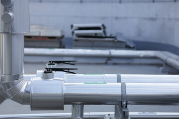 Pipe jacket aluminum work point where the  lever operated valve protrudes. Lever operated valve protruding from the cold water pipe wrapping.