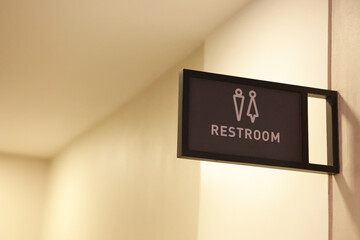 The restroom sign is mounted on the wall. Signs of male and female restrooms are installed for users to see clearly.