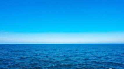 Obraz premium A serene photograph of the vast ocean under a clear blue sky, showcasing the beauty and tranquility of the sea, blue sky, tranquil