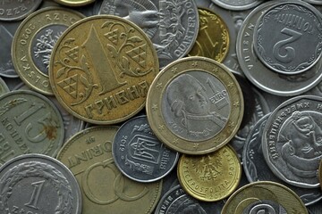 Naklejka premium Big pile of different coins from various currencies and different countries around the world. Currency exchange