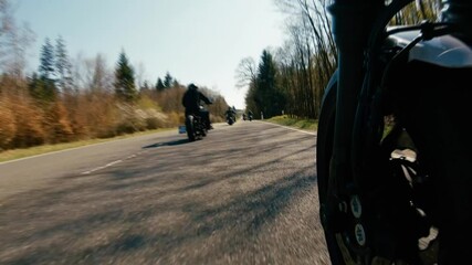 motorbike on the forest road riding. Friends having fun driving the empty road on a motorcycle tour journey. - Powered by Adobe
