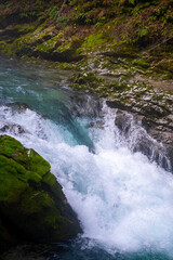 gorge with a river in the mountains, blue water, blue river, waterfalls, rocks and mountains