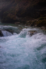 gorge with a river in the mountains, blue water, blue river, waterfalls, rocks and mountains