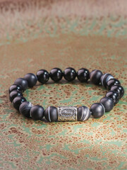 Black Obsidian stone bracelet , Chinese men's modern retro style fashion. Isolated on white...