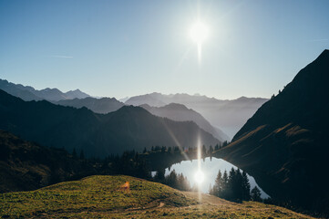 Silhouettes of Mountains Reflected in Alpsee