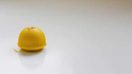 Delicious yellow laddoos on a white background.