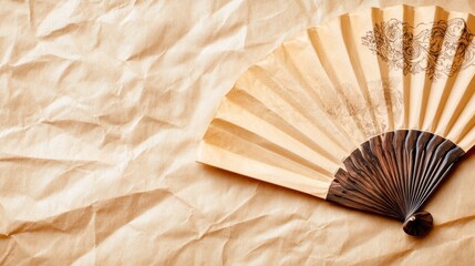 Elegant paper fan with intricate design on crumpled parchment background, AI