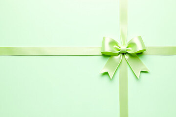 festive background a bow with a ribbon on a light green background