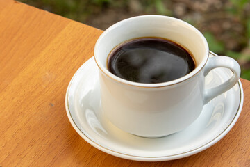 Black Coffee in Ceramic Cup on Wooden Table