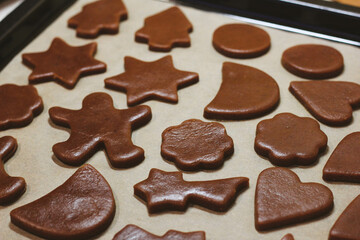 christmas gingerbread cookies on a baking tray with parchment paper