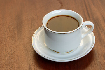 Black Coffee in Ceramic Cup on Wooden Table