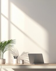 Minimalist home office desk with laptop, coffee mug, plant, and pencil holder in bright natural light setting