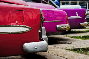 Cuban cars in beautiful shades of red, pink, and purple