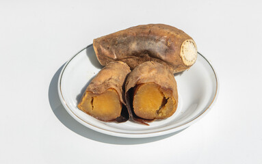 Sweet potato set on ceramic plate on white background