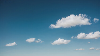 Sparse cloud group floating in a clear, vibrant sky horizon.