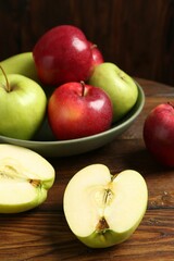 Fresh red and green apples on wooden table, closeup