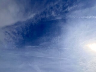 contrails and clouds in the sky