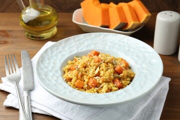 Delicious pumpkin risotto served on wooden table