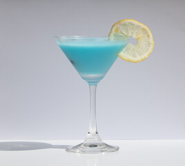 Cool and Refreshing Blue Margarita in Classic Martini Glass. Ideal for visual content focusing on refreshing drinks for warm weather.
