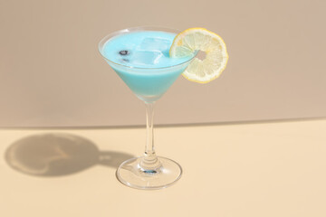 Blue cocktails garnished with blueberry and a slice of lemon