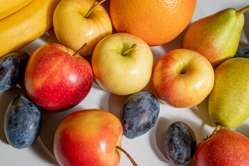 fresh fruits on a white background. healthy food fresh fruits. oranges, grapefruit, pears, apple and plums on a white background