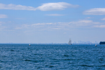 Lake Ontario with lots of boats with Mississauga downtown and skyscrapers at distance