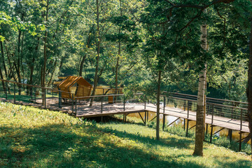 Wooden gazebo in the park on a summer day