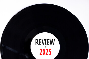 Planning review 2025 new year symbol. Concept words Review 2025 on beautiful white and black vinyl disk. Beautiful white background. Business review 2025 new year concept. Copy space.