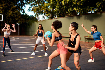 Teamwork, basketball and women playing game together for competition, challenge and fitness on...