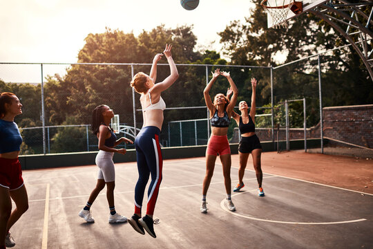 Women, sports and ball as basketball player as team as athlete for challenge, cardio and training. Female people, warm up and outdoor with competition, match or court as physical activity or exercise - Powered by Adobe