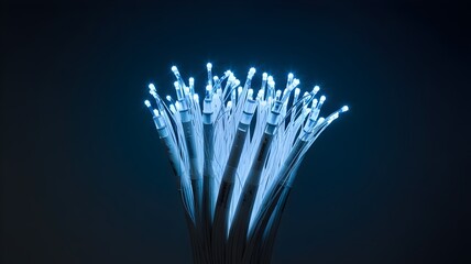 Single illuminated fiber optic cable on dark background